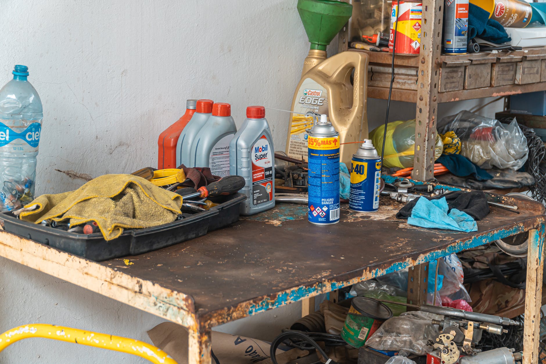 automotive oil containers on a rusty table