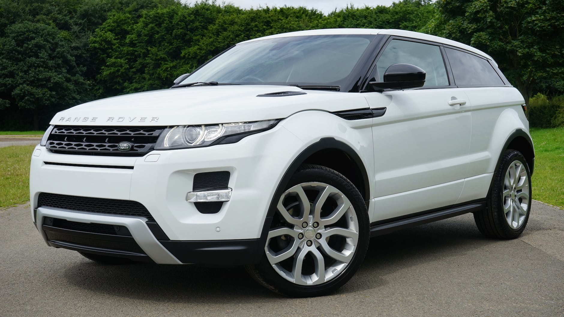 white land rover range rover suv on road
